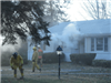 firefighters in front of smoking house