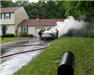 firefighters by a smoking car