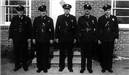 5 police officers standing together.