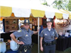 2 police officers standing together at a county fair.
